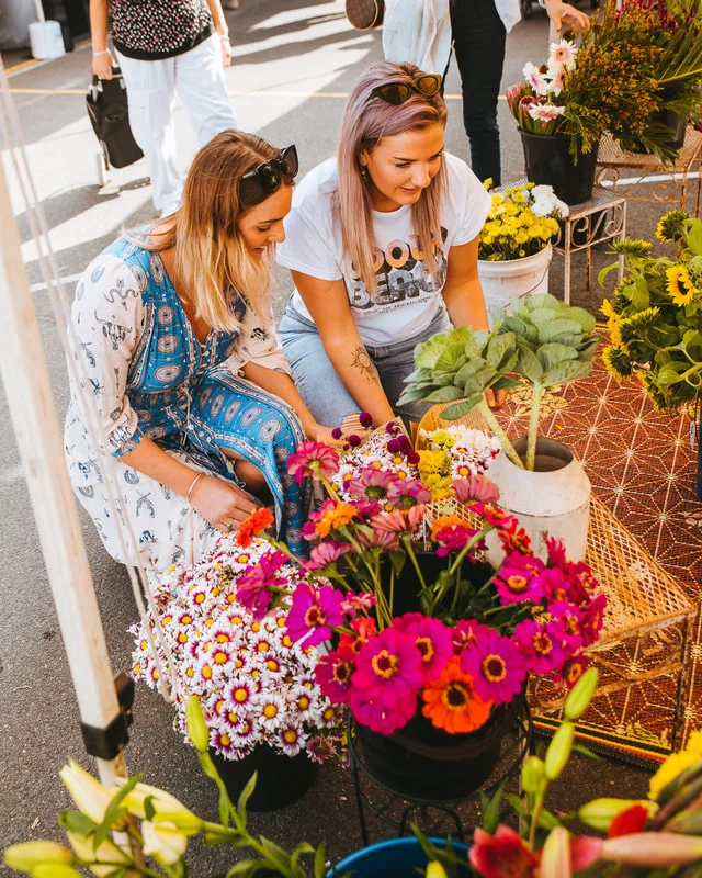 Shoppers choosing colourful flowers at Burleigh Farmers Market